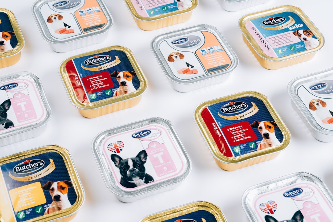 Premium pet food products arranged on cream background